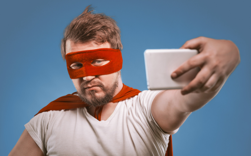 A Google My Business expert, dressed in a red superhero mask and cape, takes a selfie with a smartphone against a bright blue background, symbolizing expertise and heroism in managing business profiles A Google My Business expert, dressed in a red superhero mask and cape, takes a selfie with a smartphone against a bright blue background, symbolizing expertise and heroism in managing business profiles